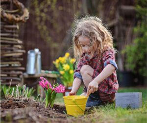 child planting seeds
